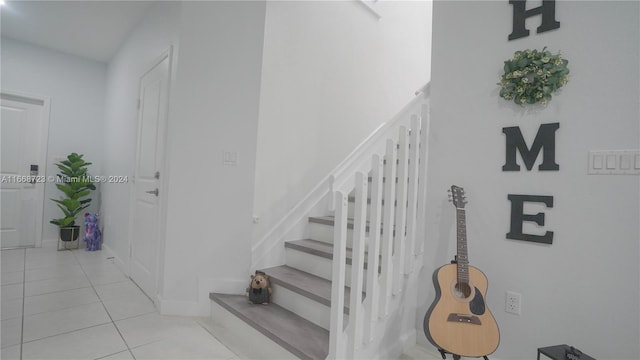 staircase with tile patterned flooring