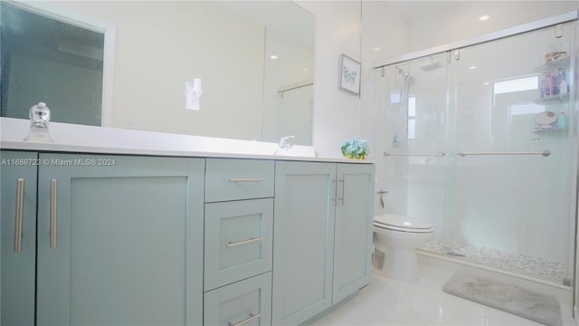 bathroom featuring tile patterned floors, a shower with shower door, vanity, and toilet