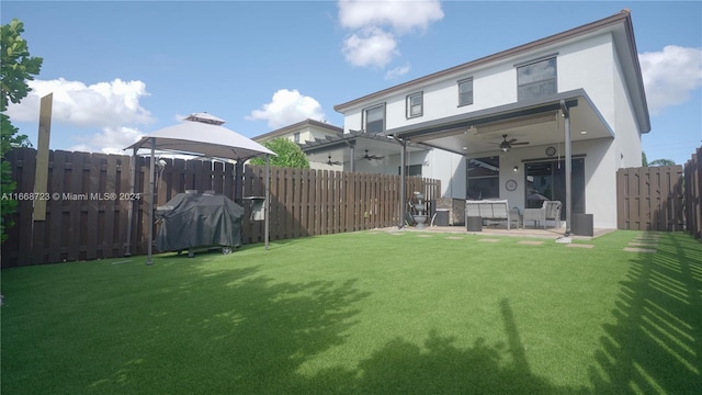 exterior space with a lawn, a gazebo, ceiling fan, and a patio area