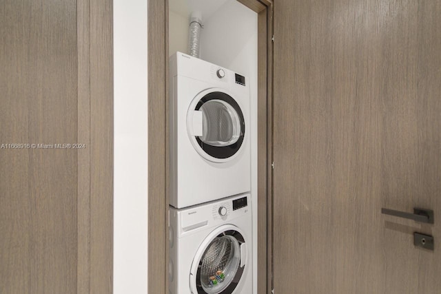 laundry area featuring stacked washing maching and dryer