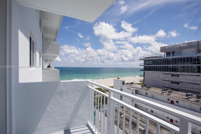 balcony featuring a water view and a beach view