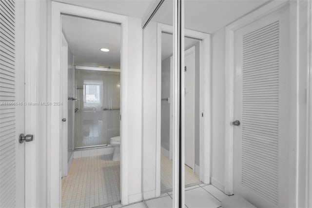 bathroom with toilet and tile patterned floors