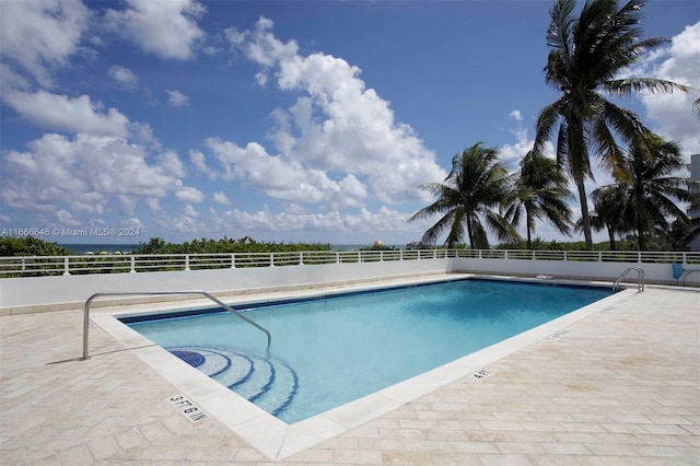 view of swimming pool with a patio area