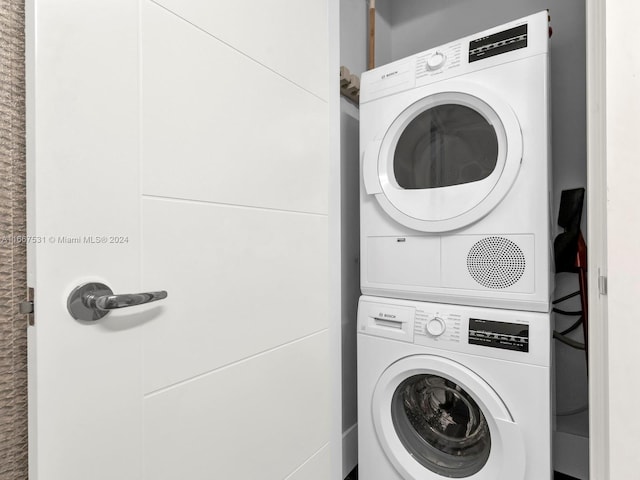 laundry room with stacked washer / dryer