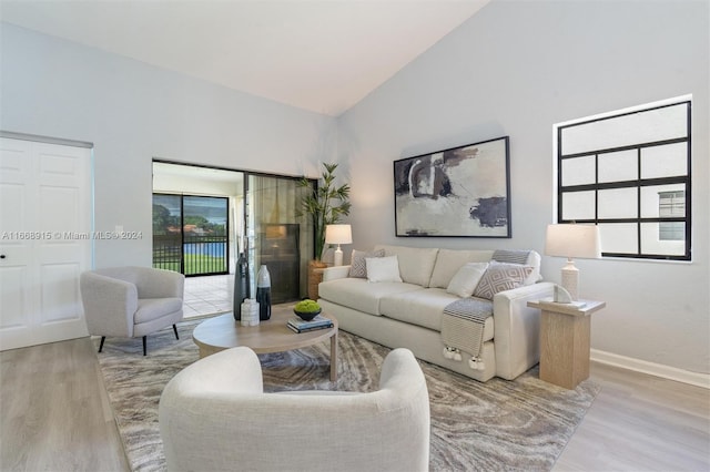 living room with lofted ceiling and light hardwood / wood-style flooring