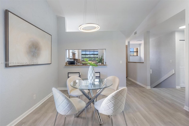 dining space with light hardwood / wood-style floors