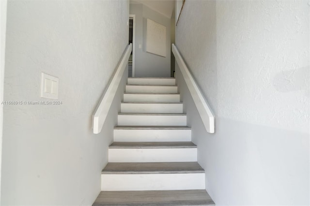 stairs with wood-type flooring