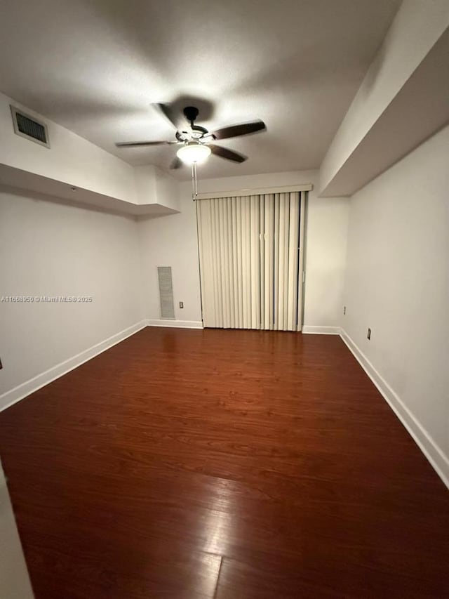 interior space featuring ceiling fan and dark wood-type flooring