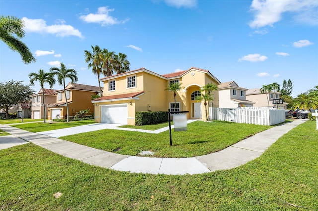 mediterranean / spanish home with a garage and a front lawn