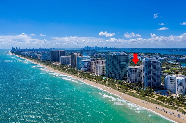 bird's eye view featuring a water view, a view of the beach, and a view of city