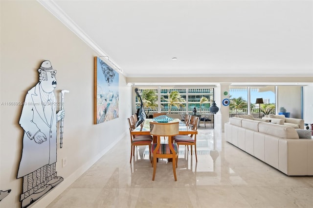 dining space with baseboards, ornamental molding, and marble finish floor