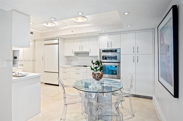 kitchen with crown molding, built in fridge, a raised ceiling, black electric stovetop, and recessed lighting
