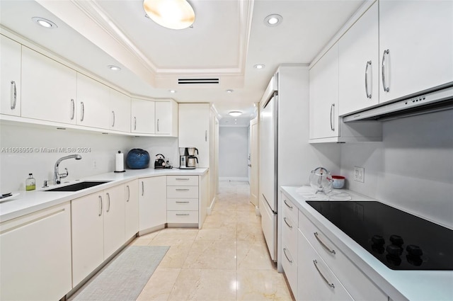 kitchen with under cabinet range hood, black electric cooktop, recessed lighting, and a sink