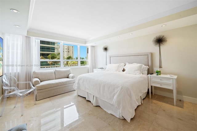 bedroom featuring baseboards, a tray ceiling, and recessed lighting
