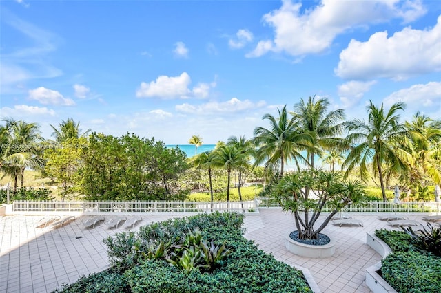 surrounding community with a water view, a patio area, and fence