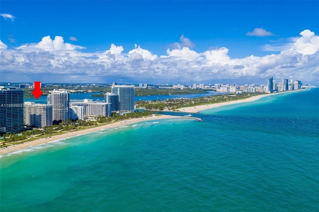 bird's eye view featuring a water view, a city view, and a view of the beach