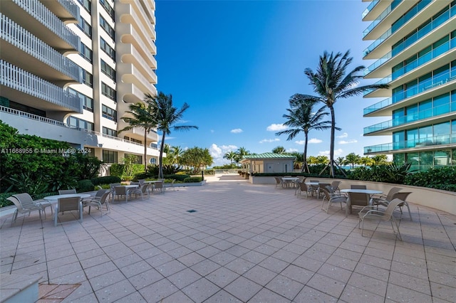 view of property's community featuring a patio and outdoor dining area