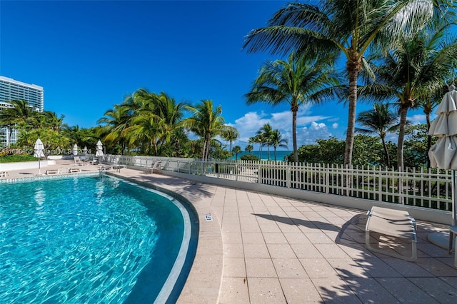pool featuring fence and a patio