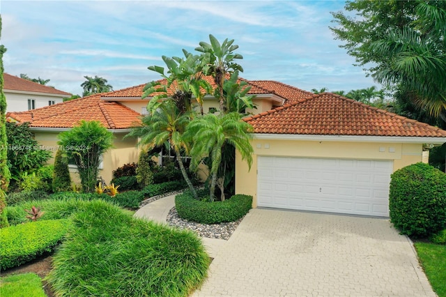 mediterranean / spanish-style home featuring a garage