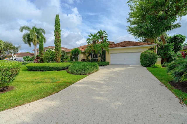 view of front of property with a front yard and a garage