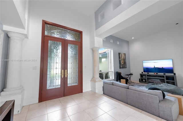 tiled entryway featuring french doors and ornate columns