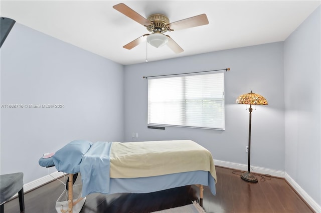 bedroom with ceiling fan and dark hardwood / wood-style floors