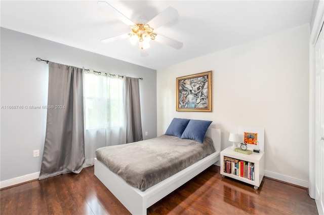 bedroom with ceiling fan and dark hardwood / wood-style floors