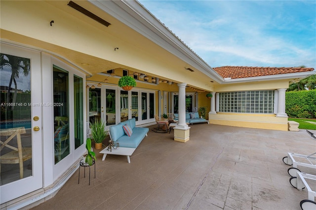 view of patio / terrace with french doors, an outdoor living space, and ceiling fan