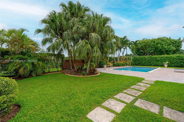 view of pool featuring a yard and a patio area