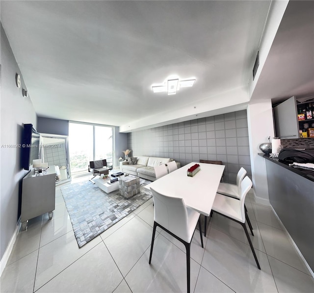 dining area with tile walls and light tile patterned floors