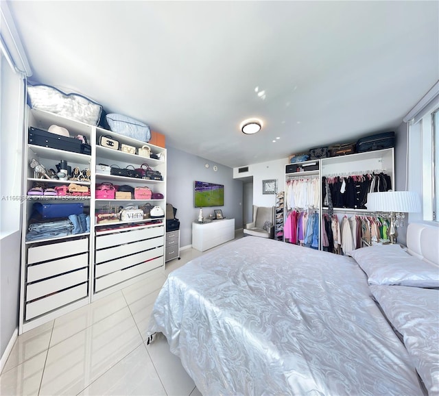 bedroom featuring a closet and light tile patterned floors