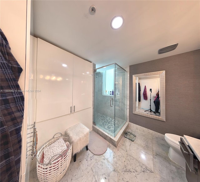 bathroom with walk in shower, vanity, and toilet