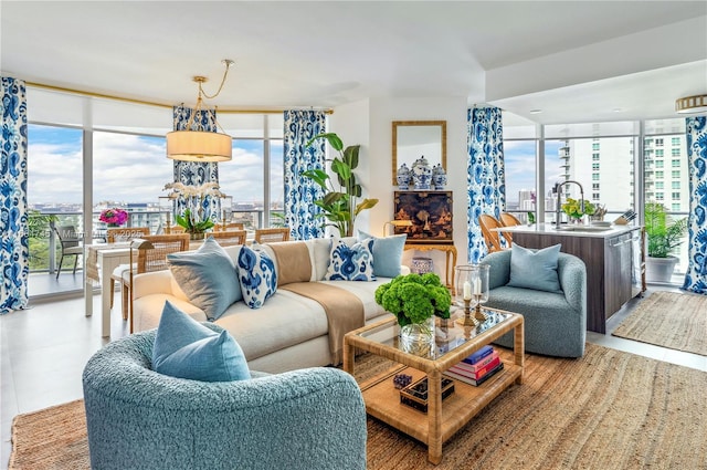 living room featuring expansive windows, light tile patterned floors, sink, and a wealth of natural light