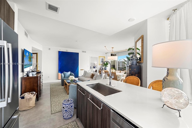 488 NE 18th St Unit 2301, Miami, FL 33132 - kitchen featuring dark brown cabinetry, freestanding refrigerator, light countertops, modern cabinets, and open floor plan
