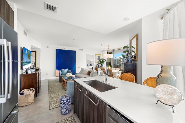 488 NE 18th St Unit 2301, Miami, FL 33132 - kitchen featuring dark brown cabinetry, freestanding refrigerator, light countertops, modern cabinets, and open floor plan