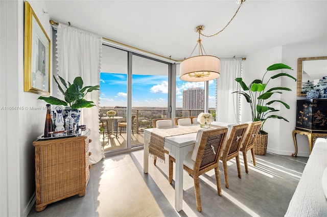 488 NE 18th St Unit 2301, Miami, FL 33132 - dining space with finished concrete floors, baseboards, and a wall of windows