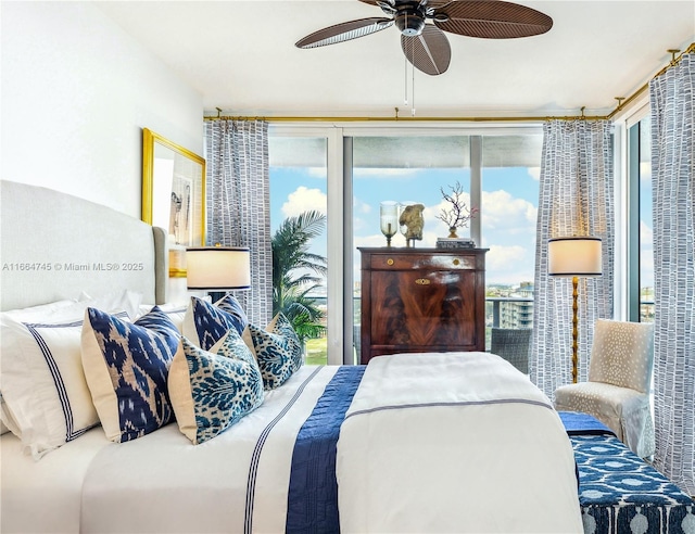 bedroom with expansive windows and ceiling fan