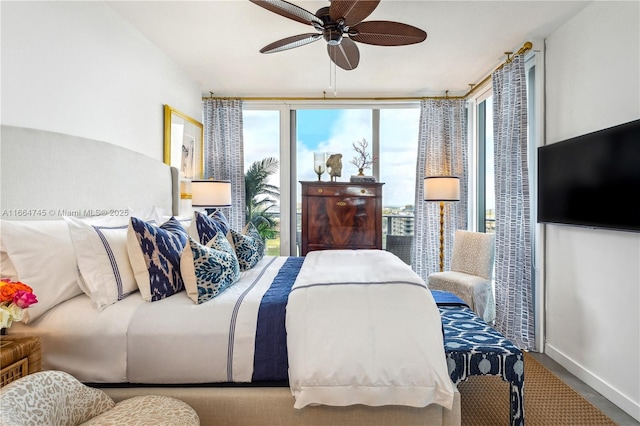 bedroom with floor to ceiling windows and ceiling fan