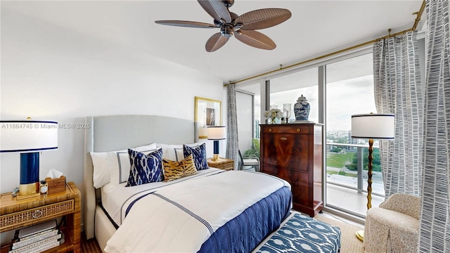 bedroom with access to exterior, expansive windows, and ceiling fan