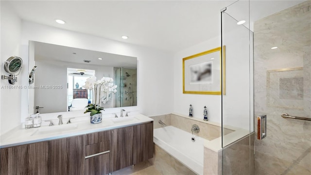 bathroom with vanity and separate shower and tub