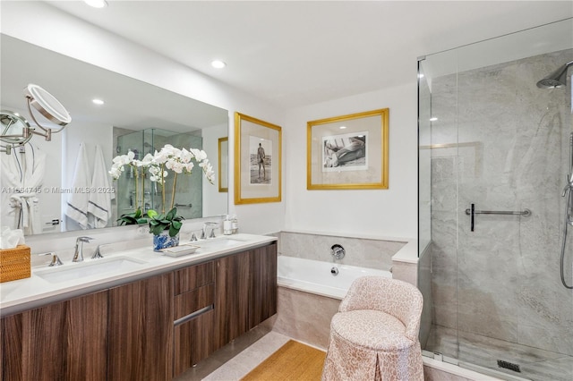 bathroom featuring vanity and separate shower and tub