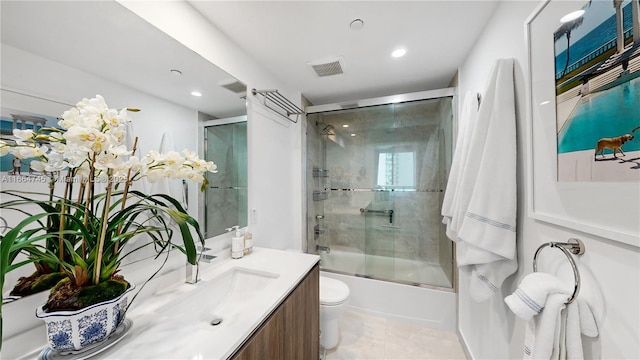 full bathroom with vanity, toilet, and combined bath / shower with glass door