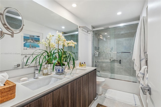 full bathroom featuring tile patterned flooring, enclosed tub / shower combo, vanity, and toilet