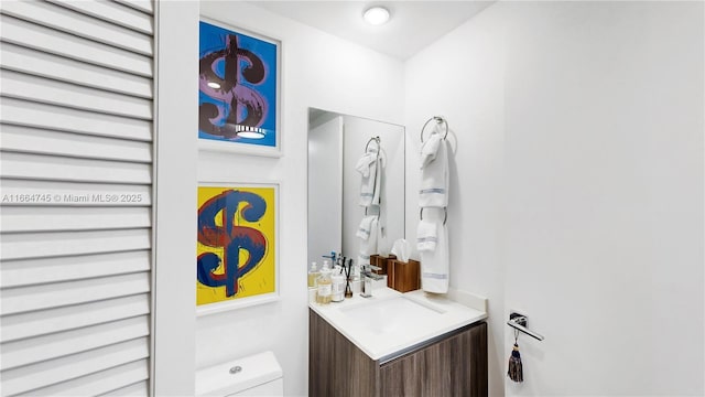 bathroom featuring vanity and toilet