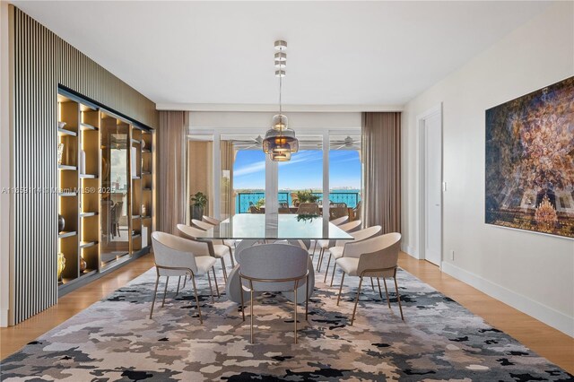 dining room with hardwood / wood-style flooring and a chandelier