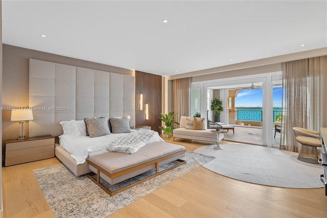 bedroom with access to outside and light hardwood / wood-style flooring