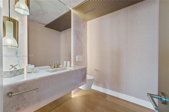 bathroom featuring toilet and hardwood / wood-style floors