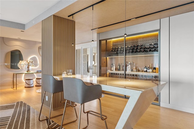 bar featuring hardwood / wood-style floors and french doors