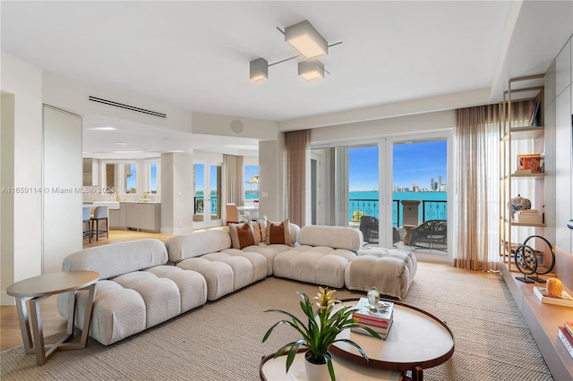 living room featuring a wealth of natural light and a water view