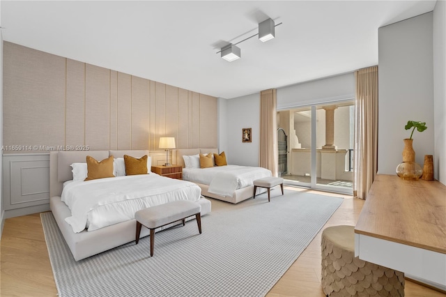 bedroom featuring light hardwood / wood-style flooring and access to outside